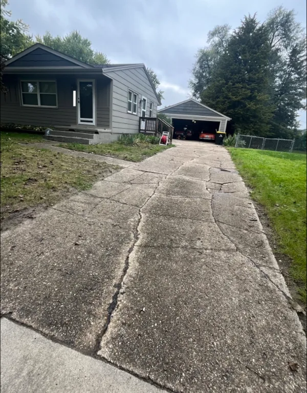 Cracked, heaving driveway before Medina Concrete replaced it